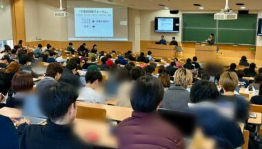 大学の講義室で、不登校に関するスライドを映して行われた講演の様子